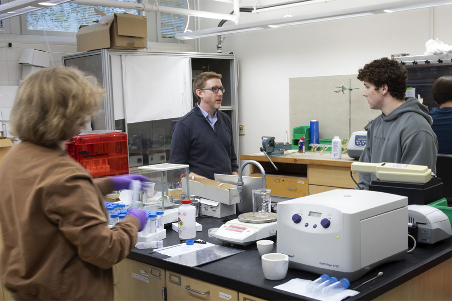 Three people work together in a lab.