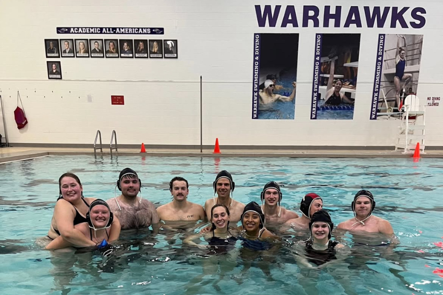 Students pose in the water for photo.