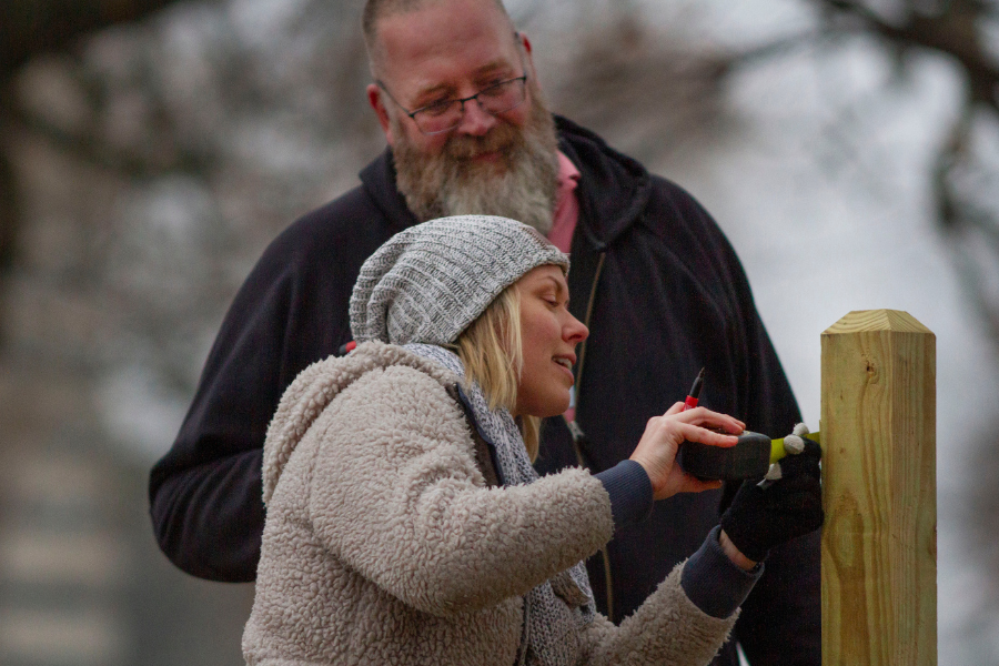 Jennalee Johnson, an early childhood education teacher at the UW-Whitewater Children’s Center, and Kevin Boehm, director of parks and recreation for the City of Whitewater, place signs for the Born Learning Trail in Starin Park.