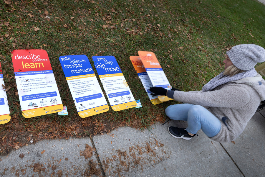 Jennalee Johnson, an early childhood education teacher at the UW-Whitewater Children’s Center, helps to arrange bilingual signs.