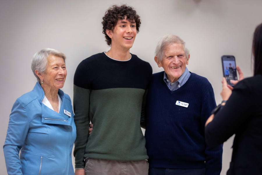 Marco poses for photo with others.