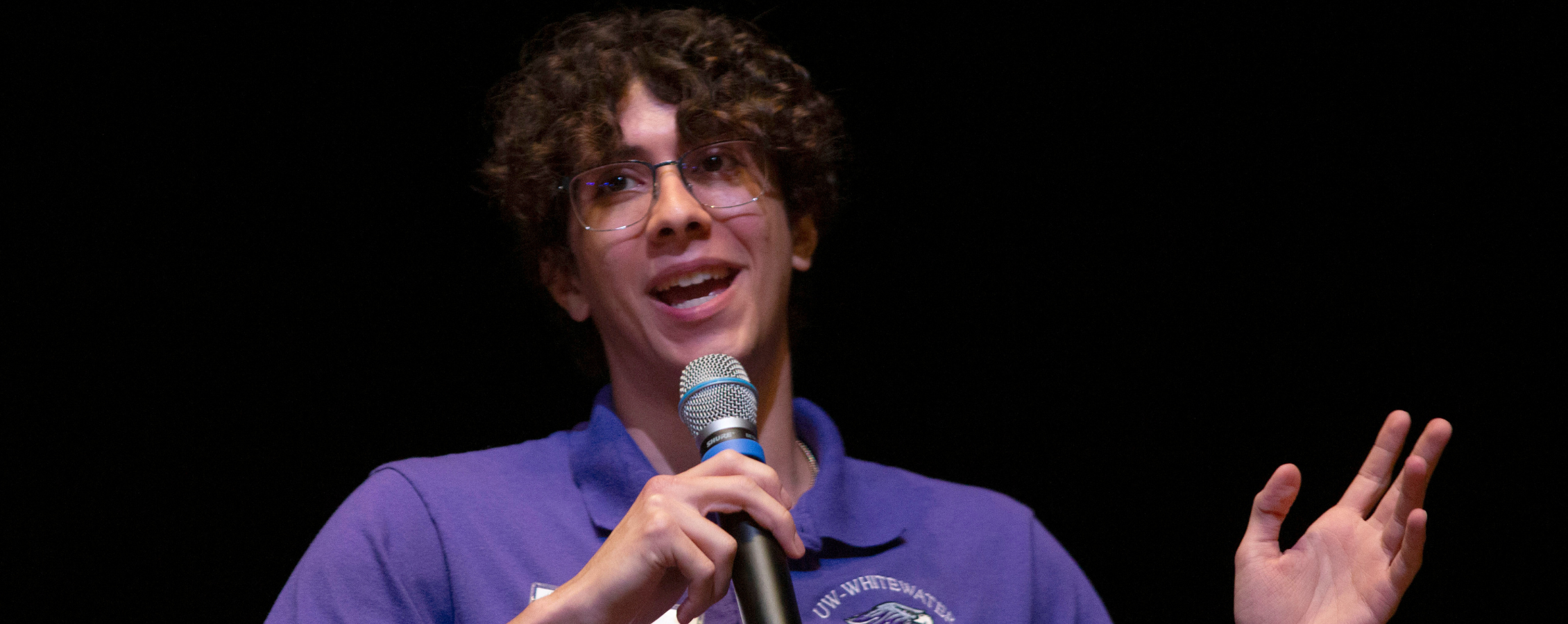 Student Marco is speaking with mic on hand.