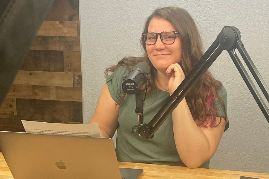 Photo of Monic sitting with a mic on the side.