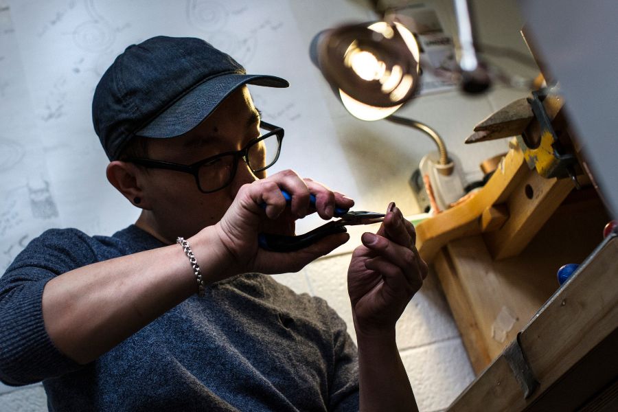 UW-Whitewater art student Ger Xiong is shown in the metal studio at Greenhill Center of the Arts as he worked to complete copper and brass pieces.