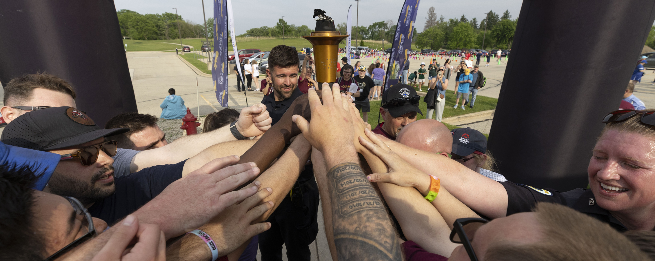 Group of people holding the torch at the Special Olympics.