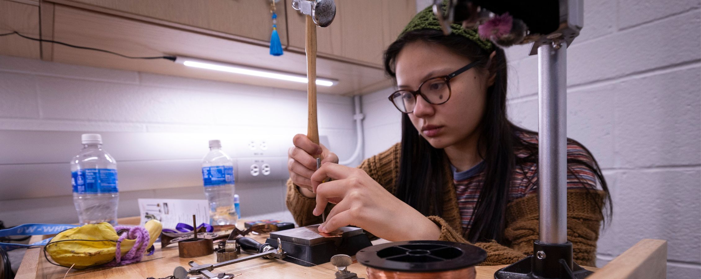 Student works on jewelry project.