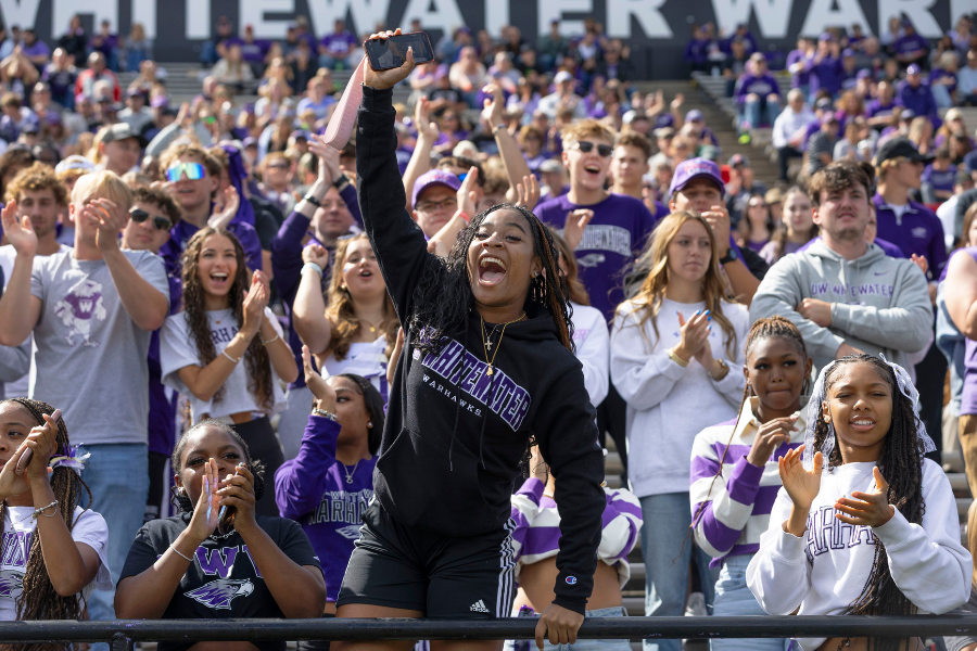 Student cheers during a football game.