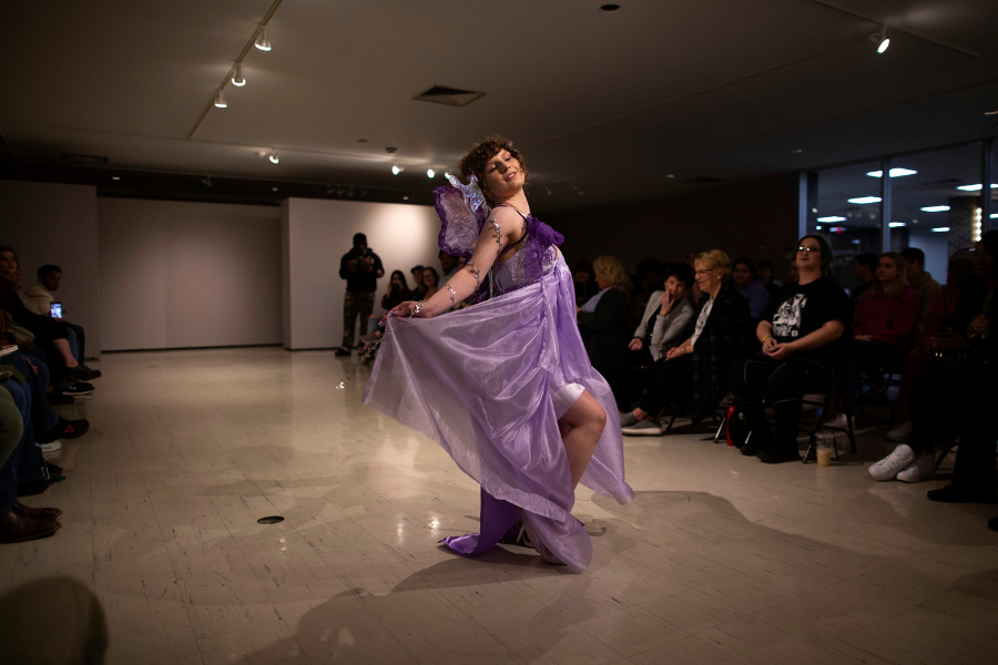 Students holds her dress during fashion show.