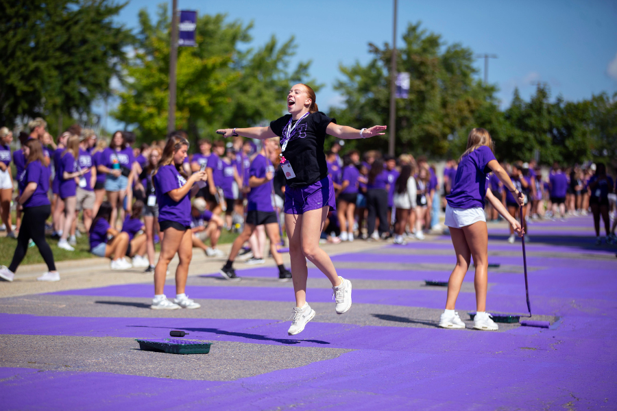 Student jumps of excitement during Paint it Purple.