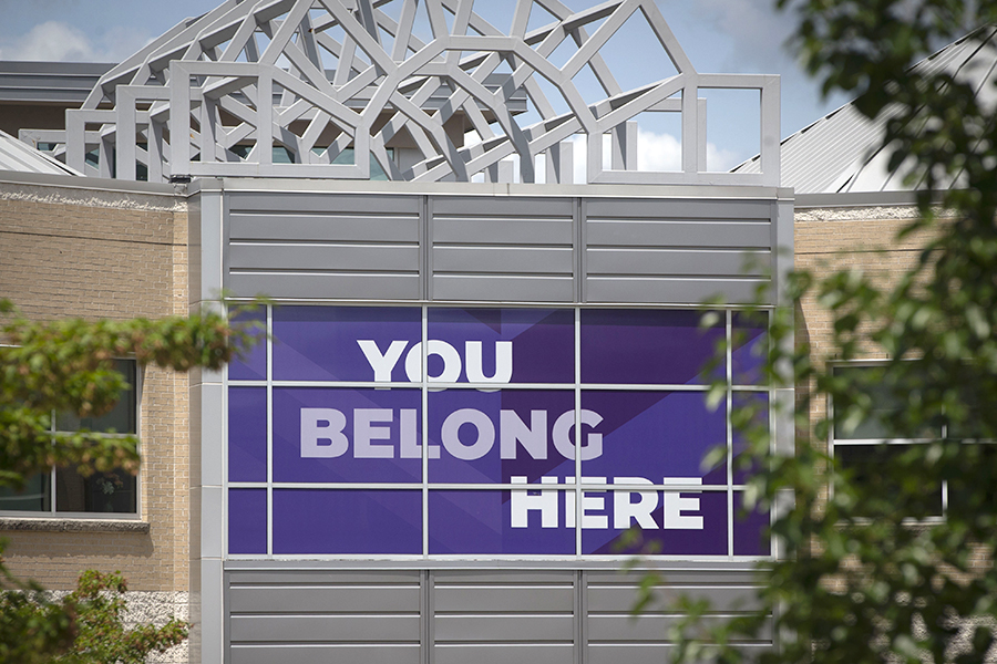 The exterior of the University Center with a purple window banner that says You Belong Here.