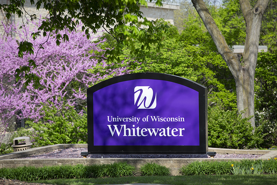 The UW-Whitewater sign surrounded by flowering trees.