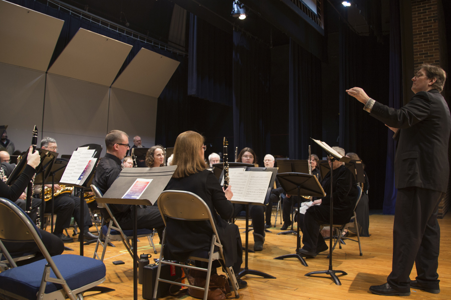 A faculty member conducts students in the Kirk Denmark Auditorium.