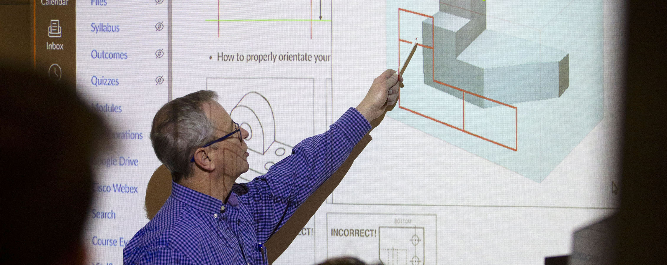 Instructor teaching engineering lesson.