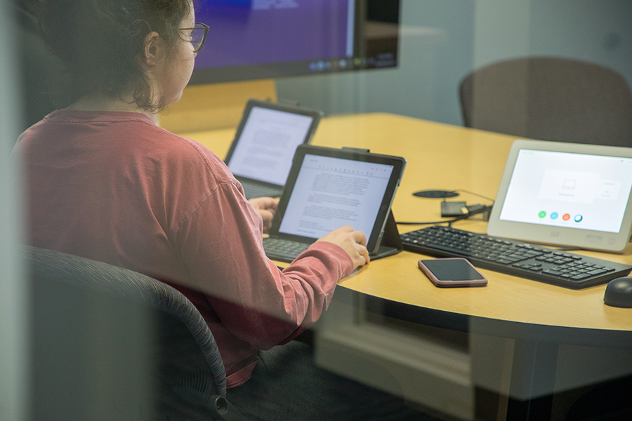 A person works on a laptop.