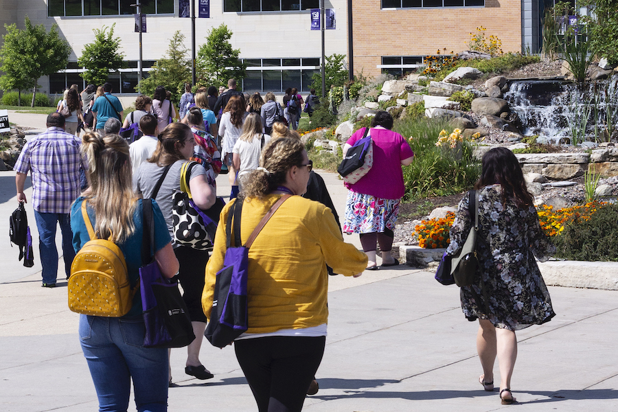 People walking outside on campus during Now is the Time Conference