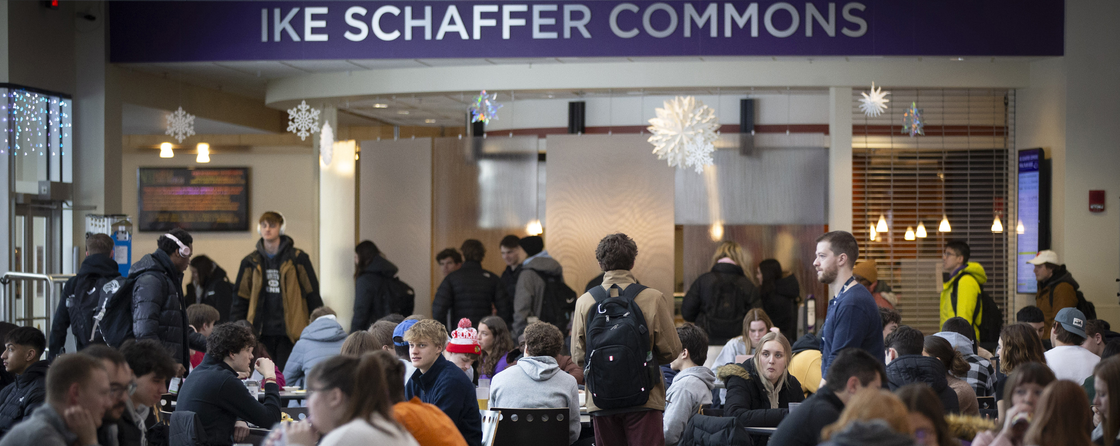 Students gather and sit at tables in the Ike Scahffer Commons.