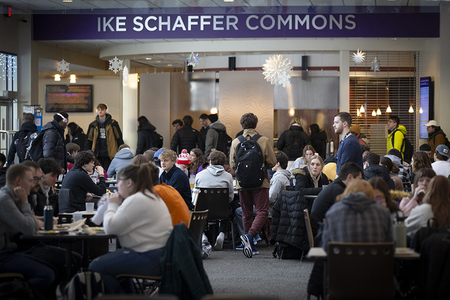 Students gather and sit at tables in the Ike Schaffer Commons.