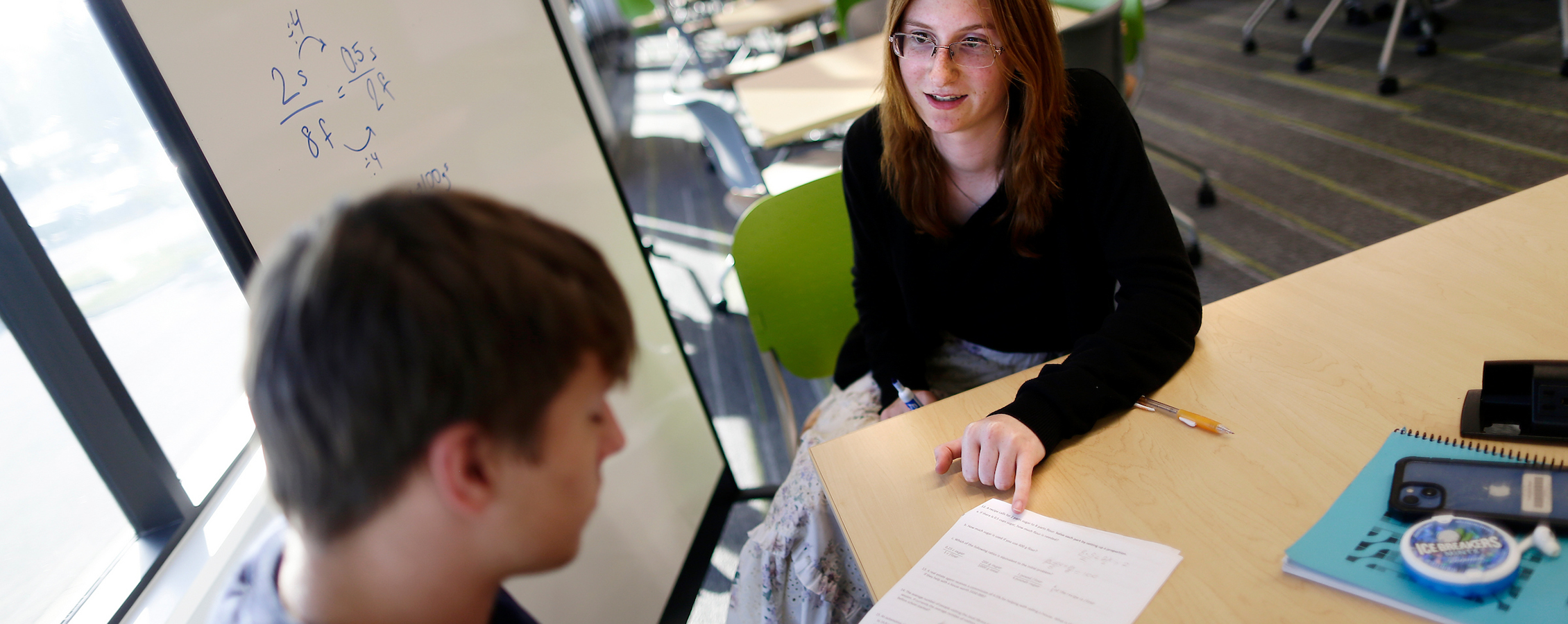 Tutor helping a student with their homework