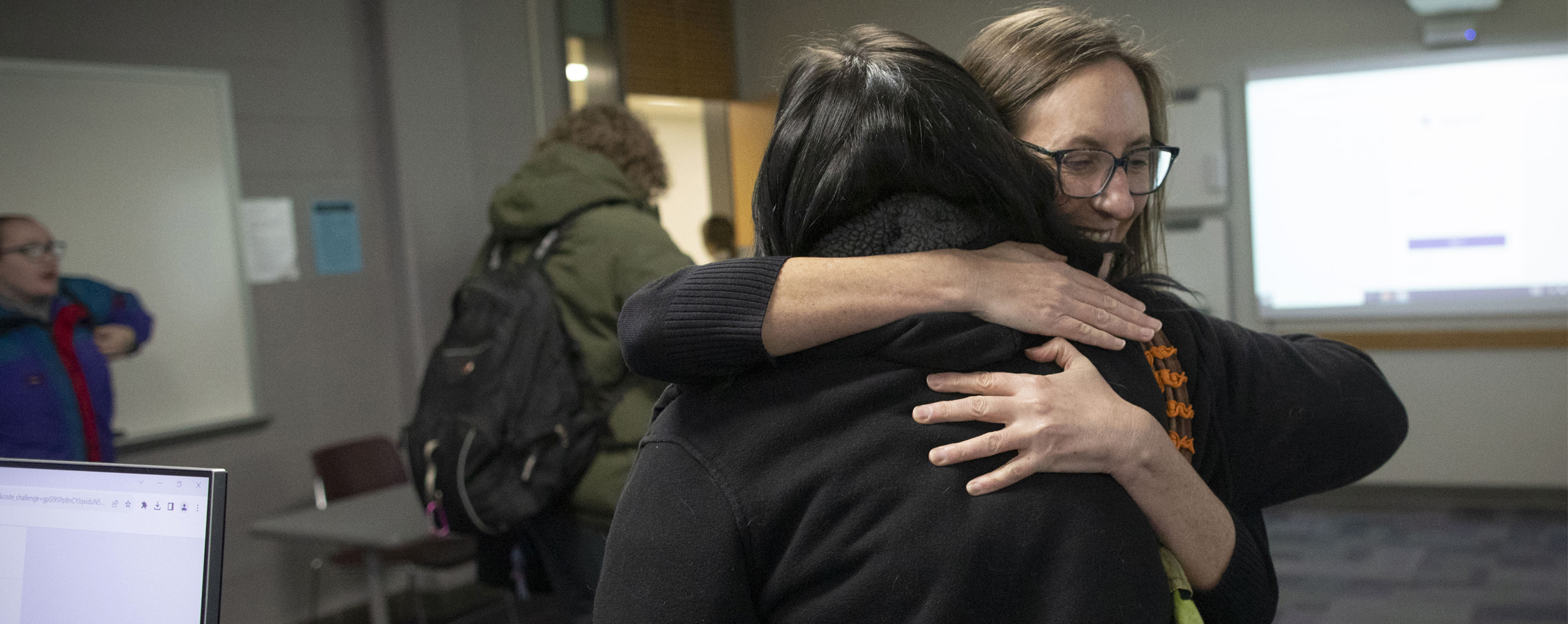 Ellie Schemenauer hugs a student goodbye.